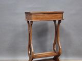 a small wooden table with a shelf on top of it