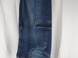 the jeans are hanging on a hanger on a white sheet