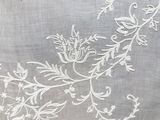a close up of a piece of embroidery on a piece of cloth