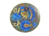 a picture of a blue and gold plate with a bird on it