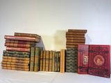 a lot of books that are stacked up on a table