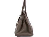 a brown leather handbag on a white background