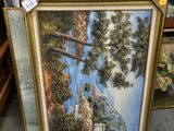 une photo d'un tableau représentant un paysage de montagne, dans un cadre