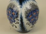 a blue and white vase sitting on a table