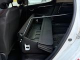 a small car with the back door open and the seats down