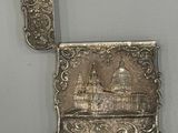 a silver plate with a picture of a building on it