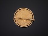 an image of a gold coin with a bar sticking out of it