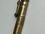 a small brass object with a rope attached to it