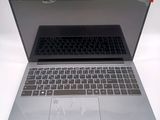 a silver laptop with a black keyboard sitting on a white surface