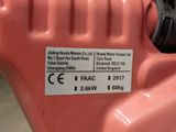 a label on the side of a pink electric drill