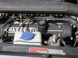 a close up of a car ' s engine with its hood open
