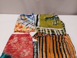 four different colored tie dyes laid out on a white surface