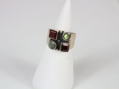 a close up of a ring with a green stone on it