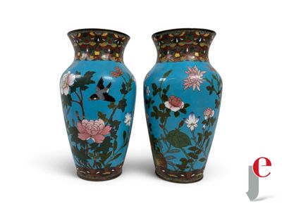 pair of blue vases with flowers and birds on them on a white background