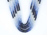 a close up of a multi strand of blue and white beaded necklace