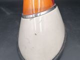 a close up of a white and orange light on a black surface