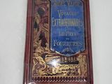 an old book on a white surface with a blue cover