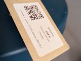 a tag hanging from the handle of a blue chair