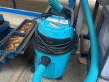 a blue vacuum that is sitting on the ground