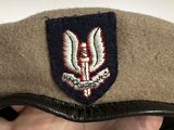 a person wearing a hat with a military emblem on it