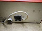 a white and red box with a white cord attached to it