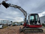 a small excavator that is sitting on the ground