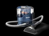 an image of a vacuum cleaner with a hose on a black background