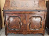 a small wooden cabinet with two doors on top of it