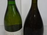 two bottles of wine sitting next to each other on a table