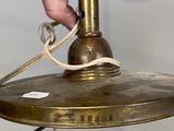 a person that is holding a light that is on top of a table