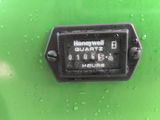 a close up of a water meter on a green surface