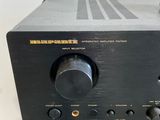 a close up of a black amplifier on a stand in a room