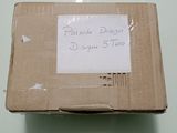 a cardboard box with a sign on it sitting on a table