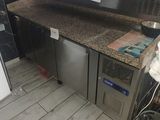 an image of a kitchen with a counter and a refrigerator