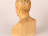 marble bust of a young man with short hair on a white background