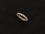 a white gold ring with diamonds on a black background