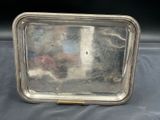 an antique silver tray with beaded edges on a table