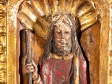 statue of a man holding a staff in a gold frame