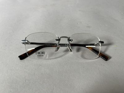 glasses on a white surface with a pair of glasses on top of it