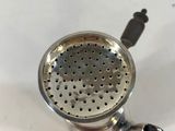 a silver strainer sitting on top of a sink
