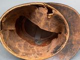 a brown hat that has a hole in the middle of it