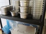 many pots and pans on a shelf in a kitchen