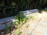 a pile of metal pipes sitting in the middle of a field