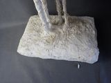 a sculpture of a giraffe that is standing on a rock
