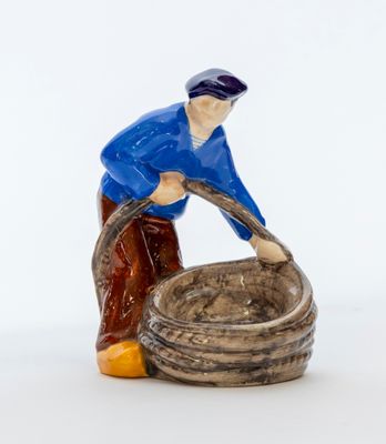 une figurine représentant un homme avec un seau d'eau