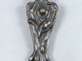 a metal object that is on a white surface