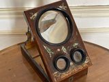 a small wooden table with a mirror on top of it