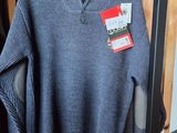 a sweater hanging on a rack in a store