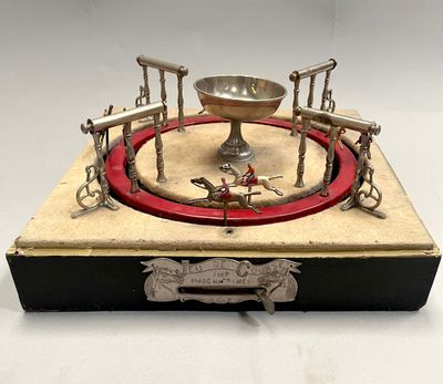 a silver plate with a red ring on top of it