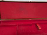 a red suitcase that is open on a white surface